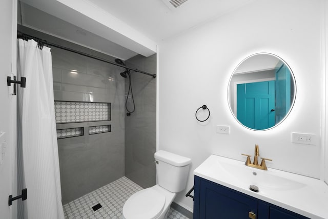 bathroom featuring a tile shower, toilet, and vanity