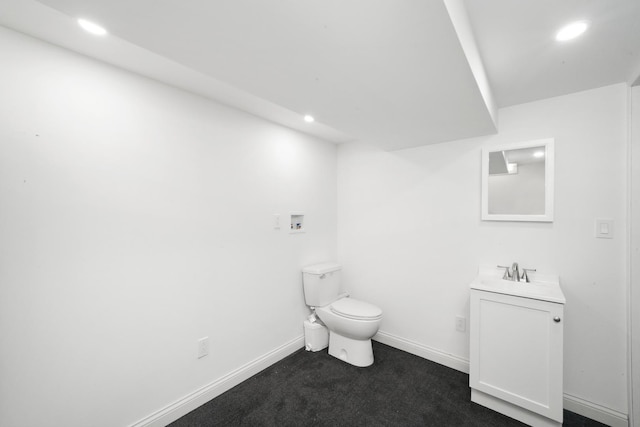 half bath with recessed lighting, baseboards, toilet, and vanity