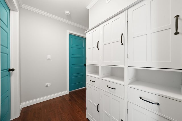 hall featuring crown molding, baseboards, and dark wood-style flooring