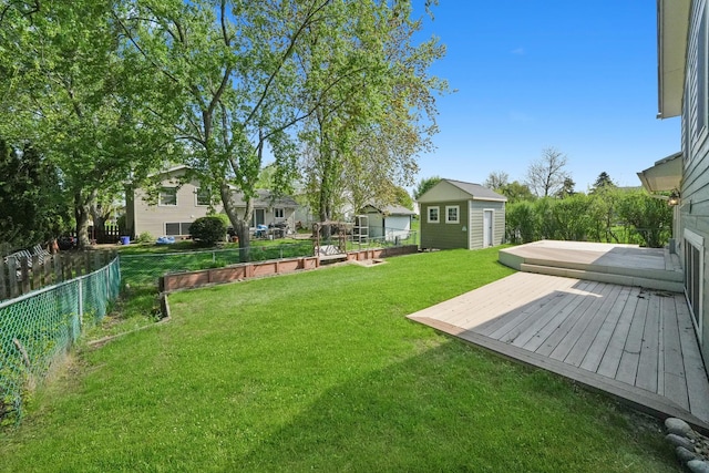 view of yard featuring a deck and an outdoor structure