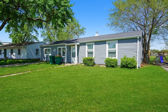 631 Fenton Ave, Romeoville, IL 60446 - back of property featuring a lawn and a chimney
