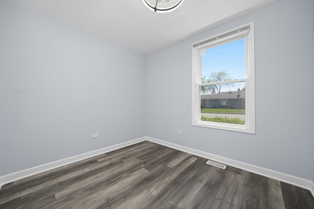631 Fenton Ave, Romeoville, IL 60446 - spare room with dark wood-style floors and baseboards