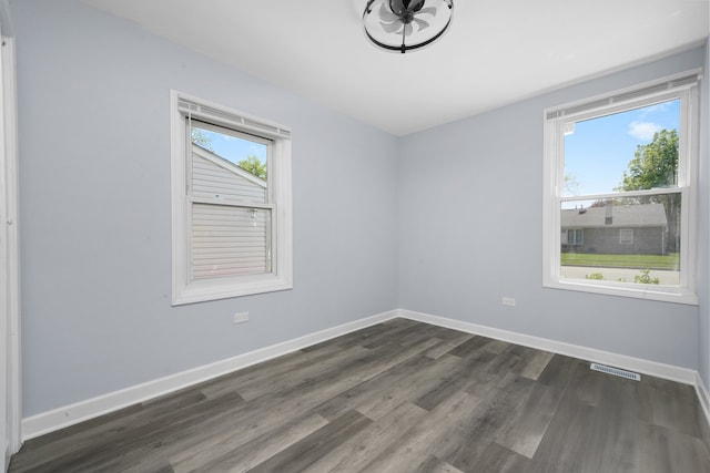 631 Fenton Ave, Romeoville, IL 60446 - unfurnished room with dark wood-type flooring and baseboards