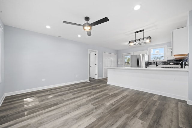 631 Fenton Ave, Romeoville, IL 60446 - unfurnished living room featuring wood finished floors, recessed lighting, a sink, ceiling fan, and baseboards