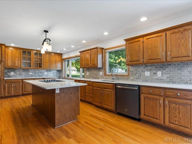 48W142 Milnamow Dr, Maple Park, IL 60151 - kitchen with stainless steel dishwasher, brown cabinets, light wood finished floors, backsplash, and recessed lighting