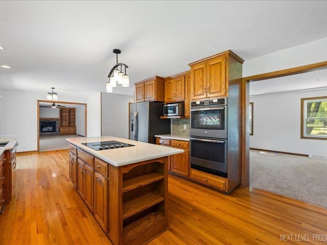 48W142 Milnamow Dr, Maple Park, IL 60151 - kitchen with stainless steel appliances, brown cabinetry, and open shelves