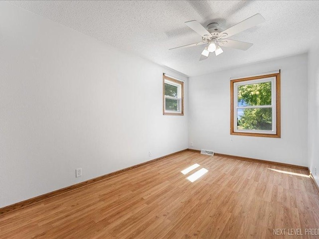 48W142 Milnamow Dr, Maple Park, IL 60151 - empty room with light wood-style flooring, a textured ceiling, and a ceiling fan