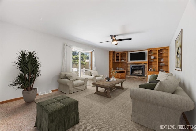 48W142 Milnamow Dr, Maple Park, IL 60151 - living area featuring a ceiling fan, a brick fireplace, light carpet, and built in shelves