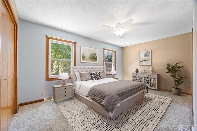 48W142 Milnamow Dr, Maple Park, IL 60151 - bedroom with light colored carpet, multiple windows, a textured ceiling, and ceiling fan
