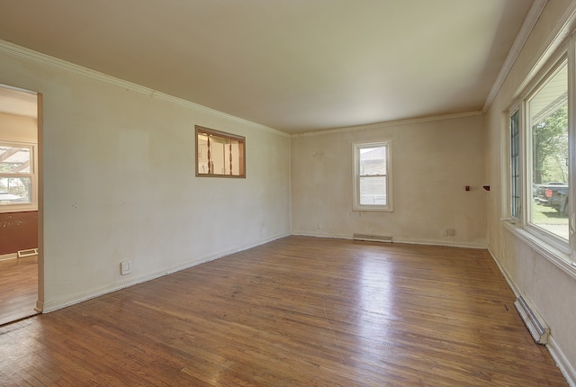 512 S Hebbard St, Joliet, IL 60433 - unfurnished room featuring wood finished floors, healthy amount of natural light, crown molding, baseboards, and a baseboard heating unit