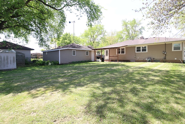 512 S Hebbard St, Joliet, IL 60433 - back of house with an outbuilding, a yard, and a shed