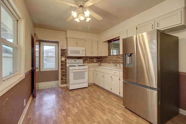 512 S Hebbard St, Joliet, IL 60433 - kitchen with white appliances, ceiling fan, light countertops, white cabinets, and baseboards