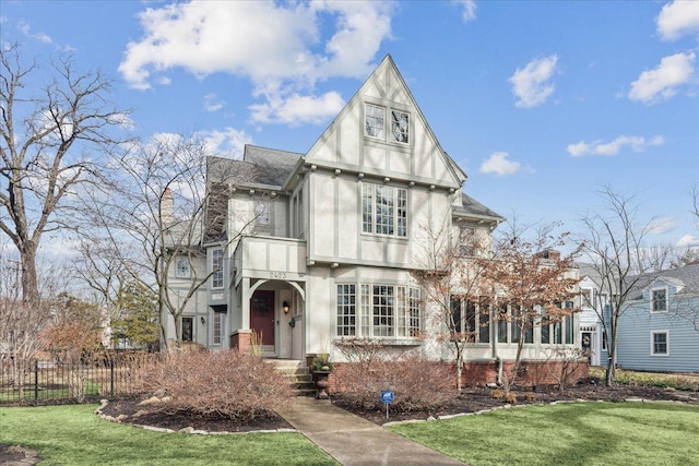 2423 Harrison St, Evanston, IL 60201 - tudor-style house featuring stucco siding and roof with shingles