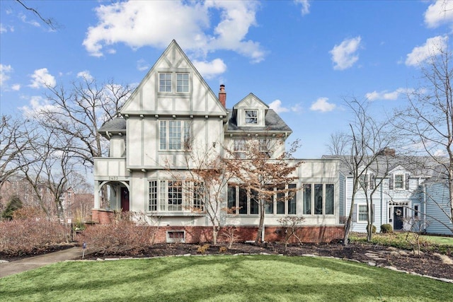2423 Harrison St, Evanston, IL 60201 - back of property featuring stucco siding, a lawn, and a chimney