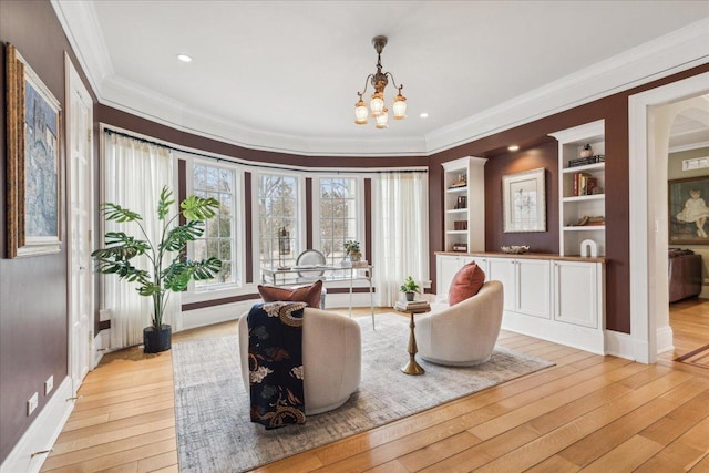 2423 Harrison St, Evanston, IL 60201 - sitting room with crown molding, a chandelier, light wood finished floors, built in shelves, and recessed lighting