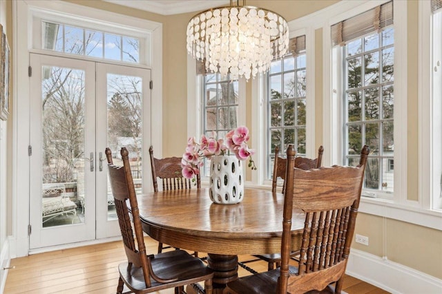2423 Harrison St, Evanston, IL 60201 - dining space with a chandelier, healthy amount of natural light, french doors, crown molding, and wood finished floors