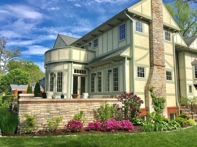 2423 Harrison St, Evanston, IL 60201 - rear view of property with board and batten siding, french doors, stucco siding, and stone siding