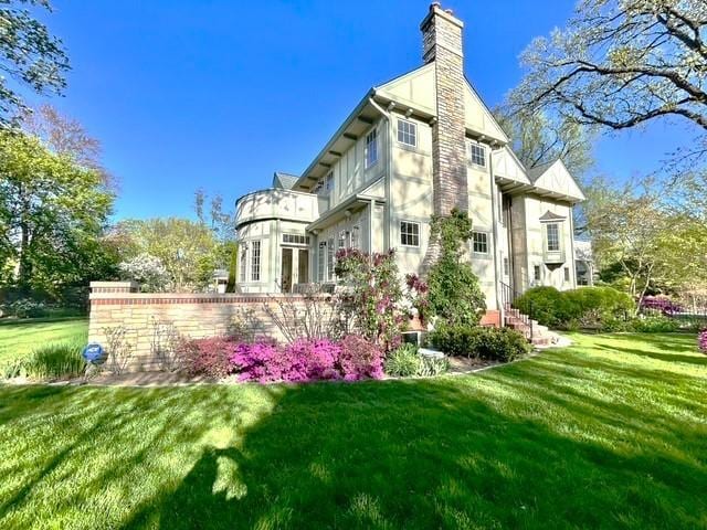 2423 Harrison St, Evanston, IL 60201 - view of home's exterior with a chimney and a lawn