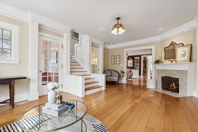 2423 Harrison St, Evanston, IL 60201 - living room with hardwood / wood-style flooring, a chandelier, stairs, a fireplace with flush hearth, and ornamental molding