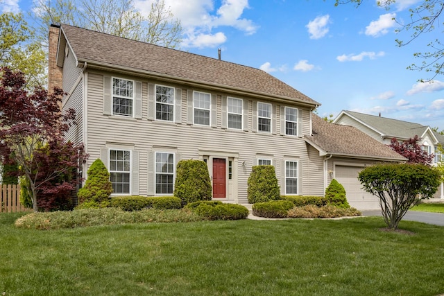 726 W Trl, Grayslake, IL 60030 - colonial-style house featuring an attached garage, a front lawn, a chimney, and a shingled roof