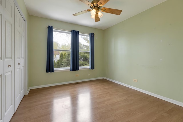 726 W Trl, Grayslake, IL 60030 - unfurnished bedroom featuring light wood-style flooring, a closet, baseboards, and ceiling fan