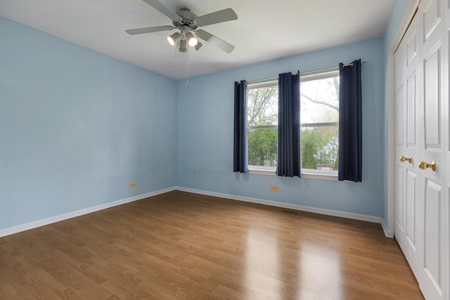 726 W Trl, Grayslake, IL 60030 - unfurnished bedroom featuring a closet, wood finished floors, baseboards, and a ceiling fan
