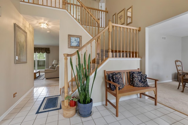 726 W Trl, Grayslake, IL 60030 - stairway with baseboards, a towering ceiling, tile patterned flooring, and carpet floors