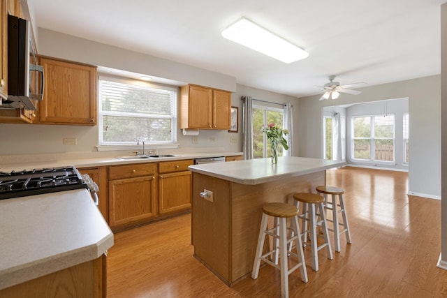 726 W Trl, Grayslake, IL 60030 - kitchen with a sink, a kitchen bar, light wood-style floors, and stainless steel microwave