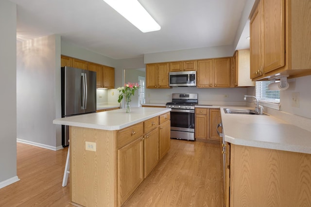 726 W Trl, Grayslake, IL 60030 - kitchen featuring stainless steel appliances, a sink, a kitchen island, and light wood-type flooring