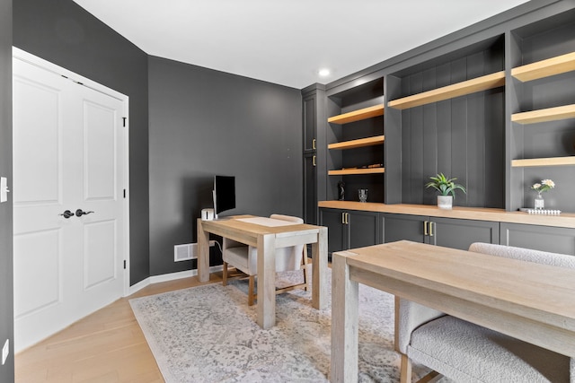 home office featuring baseboards, light wood-style floors, and recessed lighting