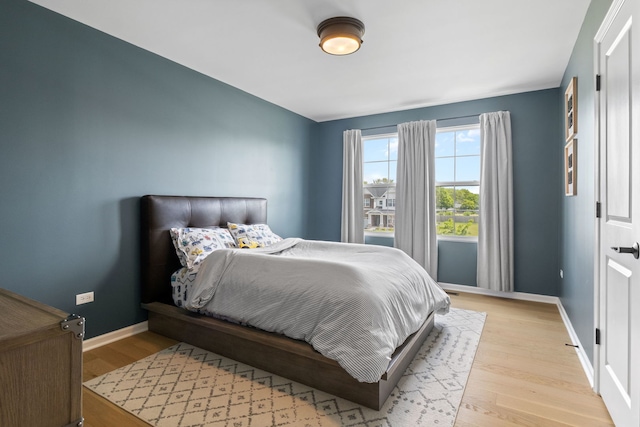 bedroom with baseboards and light wood-style floors