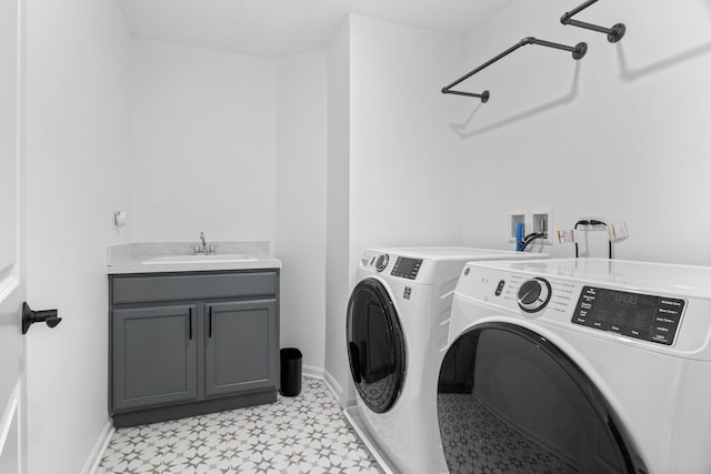washroom featuring washer and clothes dryer, light flooring, cabinet space, and baseboards