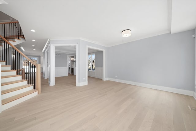 622 S Euclid Ave, Elmhurst, IL 60126 - unfurnished living room featuring crown molding, light wood-type flooring, stairs, a wainscoted wall, and recessed lighting