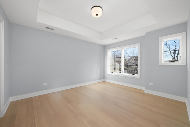 622 S Euclid Ave, Elmhurst, IL 60126 - empty room with a raised ceiling, light wood-style floors, plenty of natural light, and baseboards