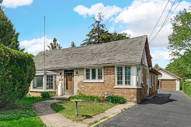 2748 Bellwood Ave, Melrose Park, IL 60164 - view of front facade with brick siding, an outbuilding, and a garage