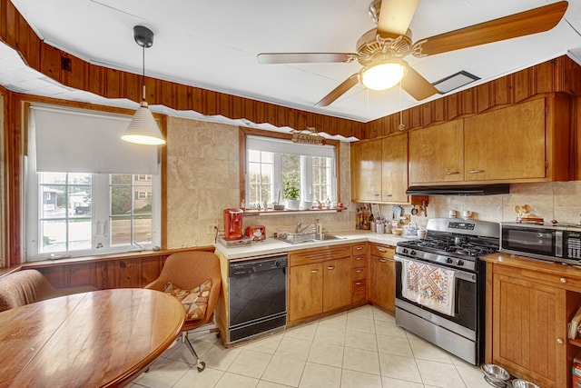 2748 Bellwood Ave, Melrose Park, IL 60164 - kitchen with appliances with stainless steel finishes, a sink, light countertops, under cabinet range hood, and decorative backsplash