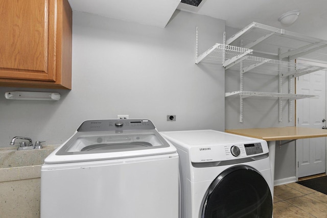 washroom featuring cabinet space and separate washer and dryer