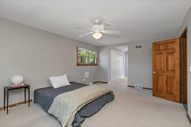 bedroom with light colored carpet, baseboards, and a closet