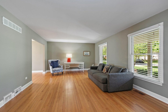 living area featuring light wood finished floors and baseboards