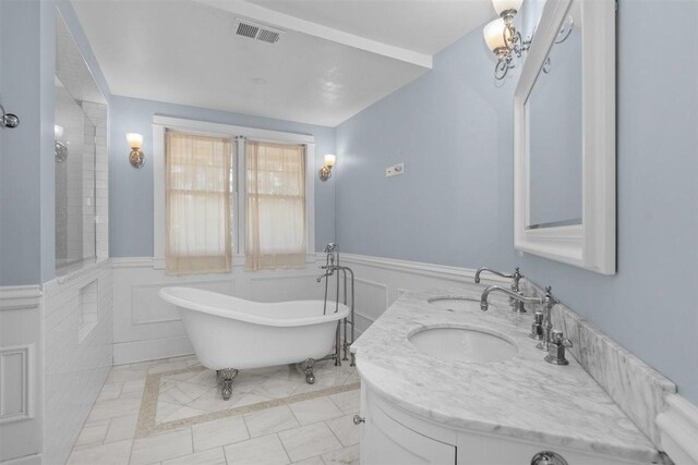 794 Dean Ave, Highland Park, IL 60035 - full bath with a soaking tub, a wainscoted wall, double vanity, inlaid floor details, and tile patterned floors