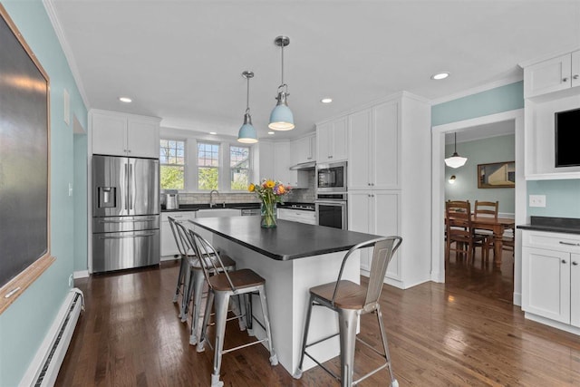 794 Dean Ave, Highland Park, IL 60035 - kitchen with stainless steel appliances, a baseboard heating unit, dark countertops, a kitchen bar, and recessed lighting