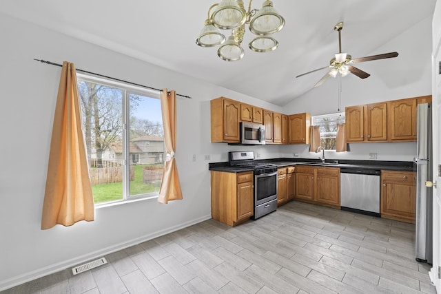 16215 S Trumbull Ave S, Markham, IL 60428 - kitchen with appliances with stainless steel finishes, a sink, brown cabinetry, healthy amount of natural light, and vaulted ceiling
