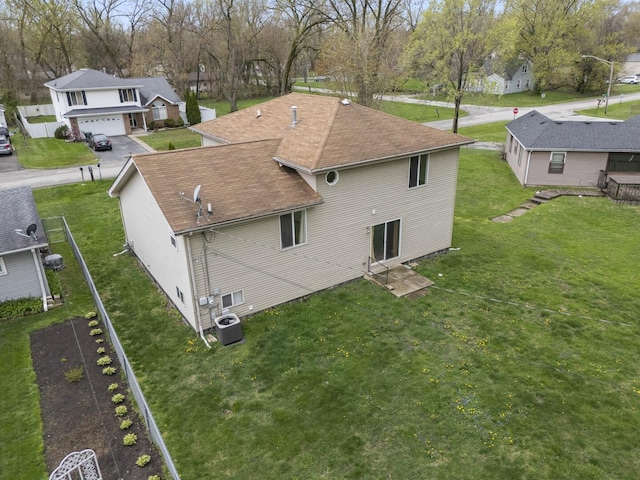16215 S Trumbull Ave S, Markham, IL 60428 - rear view of property with central air condition unit, a residential view, a shingled roof, and a yard