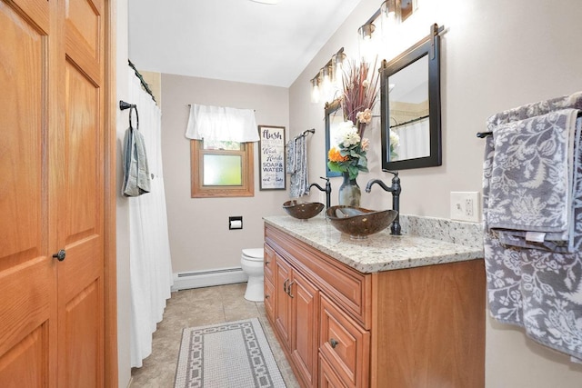 23424 W Winston Ave, Plainfield, IL 60586 - full bathroom with a baseboard heating unit, toilet, vanity, and tile patterned floors