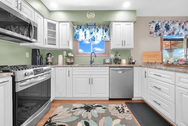 23424 W Winston Ave, Plainfield, IL 60586 - kitchen with appliances with stainless steel finishes, a sink, light wood-type flooring, white cabinets, and recessed lighting