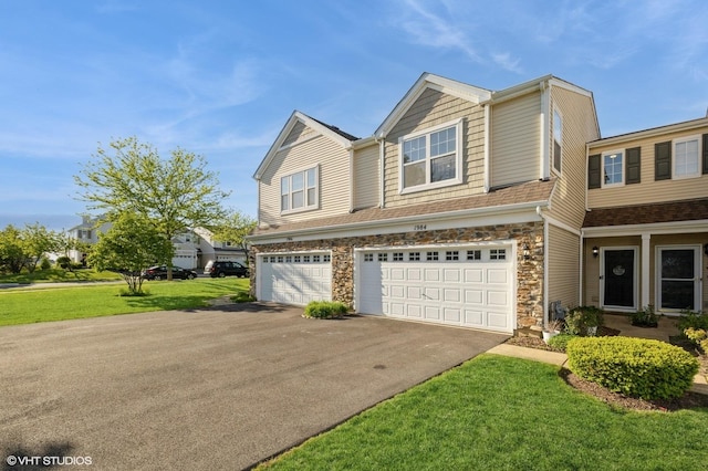 view of front of property featuring asphalt driveway, a garage, stone siding, and a front lawn
