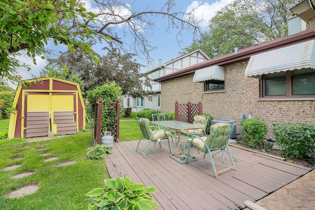 1116 N Old Fence Rd, Addison, IL 60101 - wooden terrace with a yard, outdoor dining space, and a storage unit