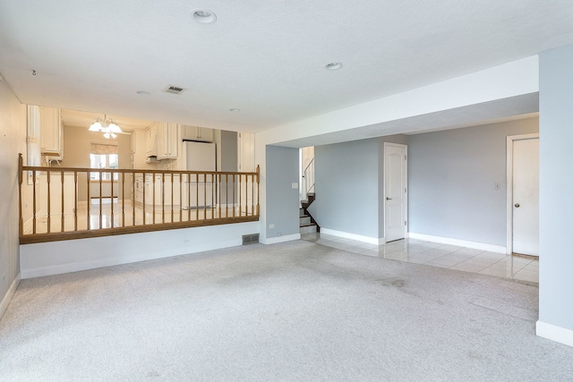 1116 N Old Fence Rd, Addison, IL 60101 - spare room featuring light colored carpet, stairs, and a chandelier