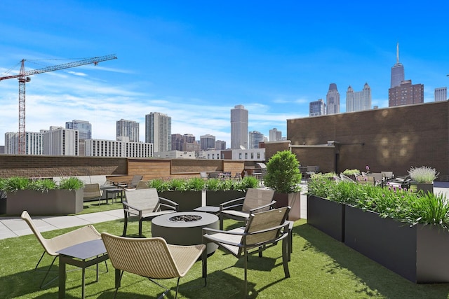 view of patio / terrace with a skyline view and a fire pit