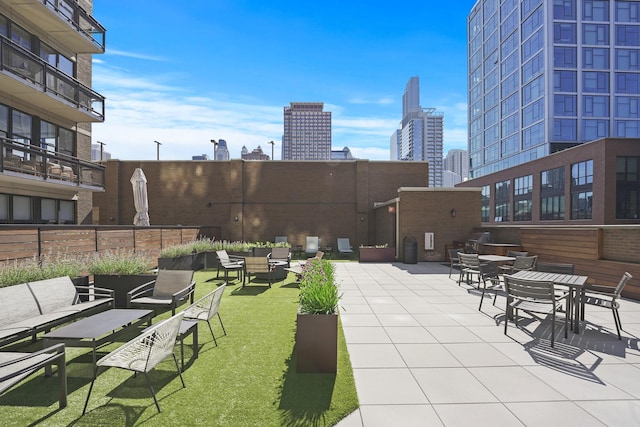 view of patio with a view of skyline and an outdoor hangout area